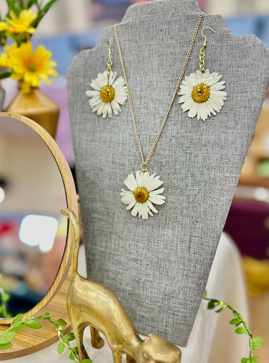 Pressed Daisy Jewellery Set. Earrings and necklace hanging from a mannequin.
