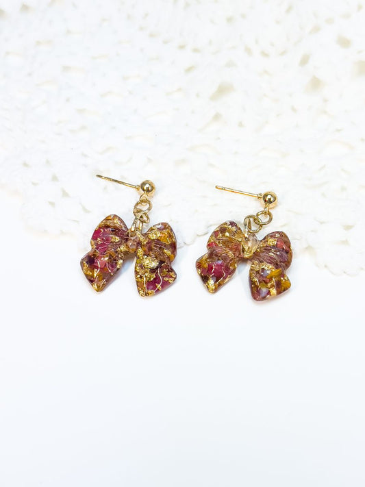 bow shaped dangle earrings made with crushed canadian maple leaves in gold.