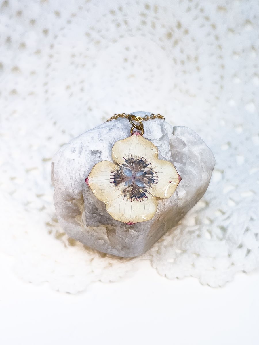 Pressed dogwood flower made into a necklace pendant.