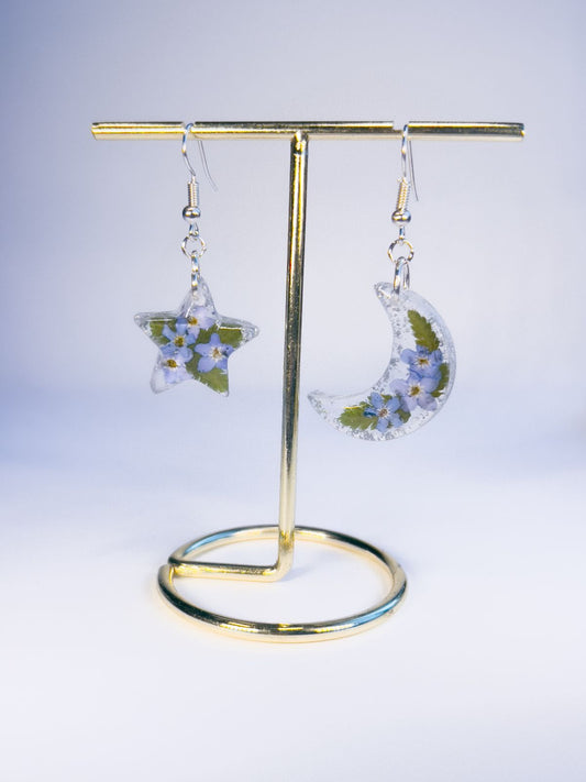 Moon and star dangle earrings made with pressed forget-me-nots and ferns.