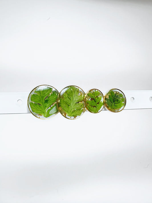 Display of Golden Kitty Jewellerys round fern stud earrings in multiple sizes.