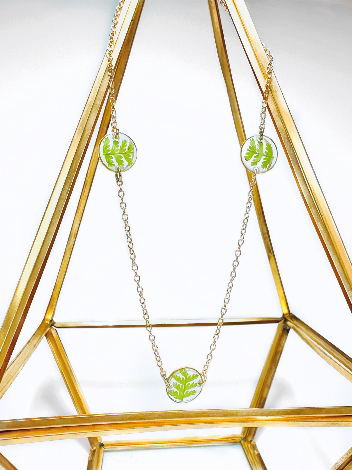 Stacking necklace made with three small pressed fern pendants.