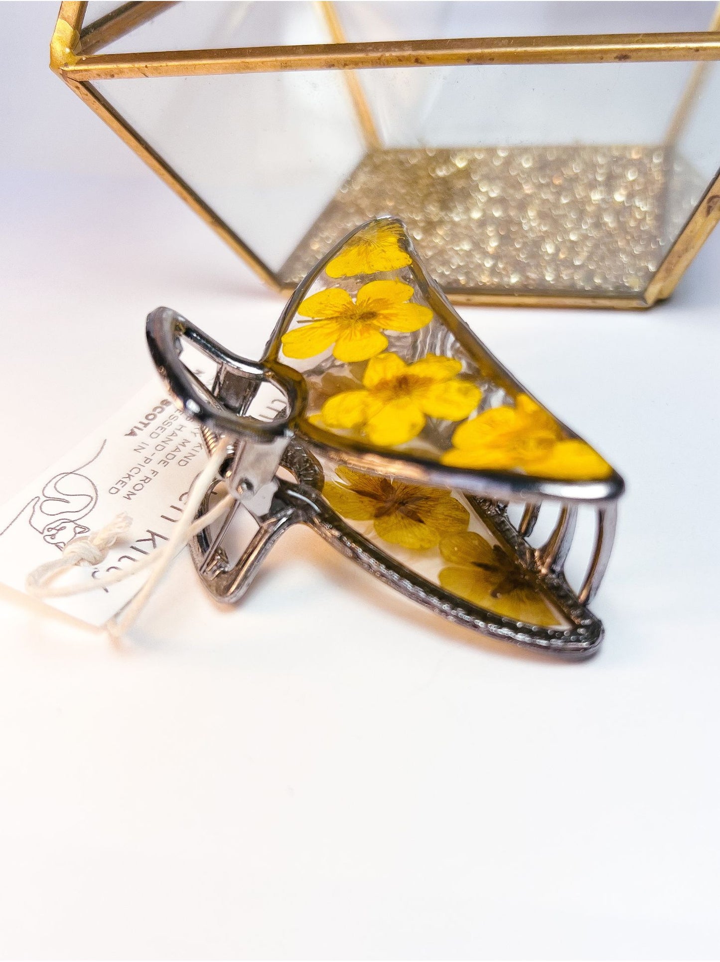 Side angle of a buttercup hair clip from Golden Kitty Jewellerys floral hair accessories collection.