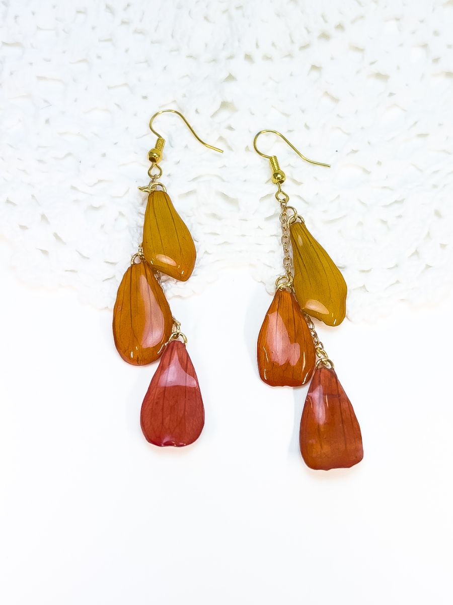 Triple petal dangles made from pressed zinnias, in gold. By Golden Kitty Jewellery.