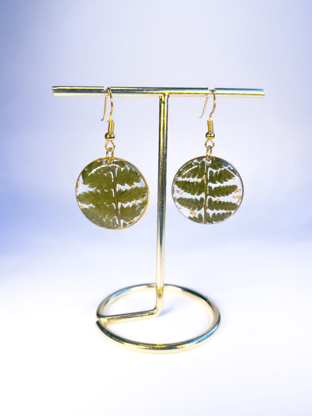 Round pendant dangle earrings made from pressed ferns in Nova Scotia. 