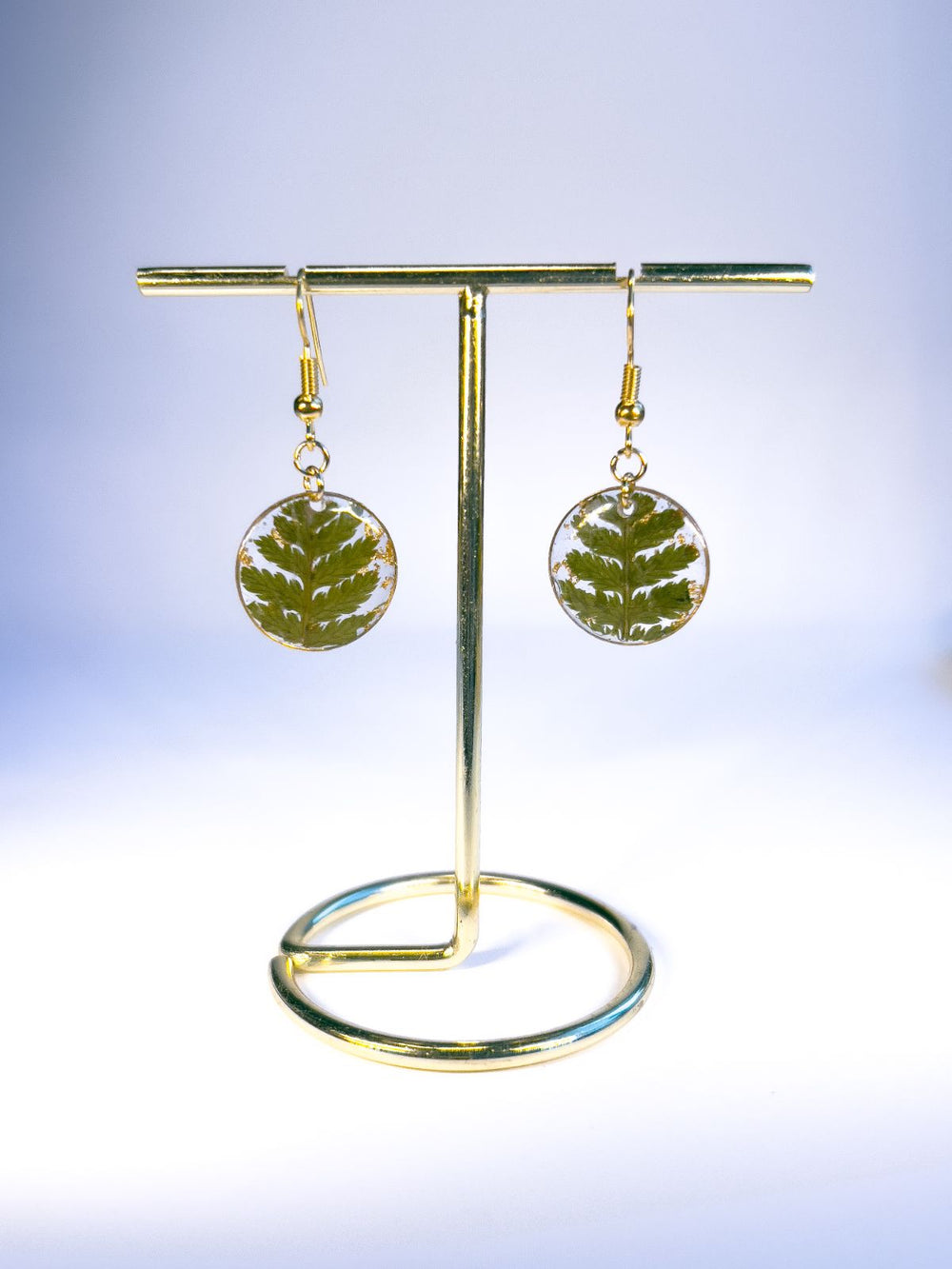 Round pendant dangle earrings in medium made with pressed ferns. 