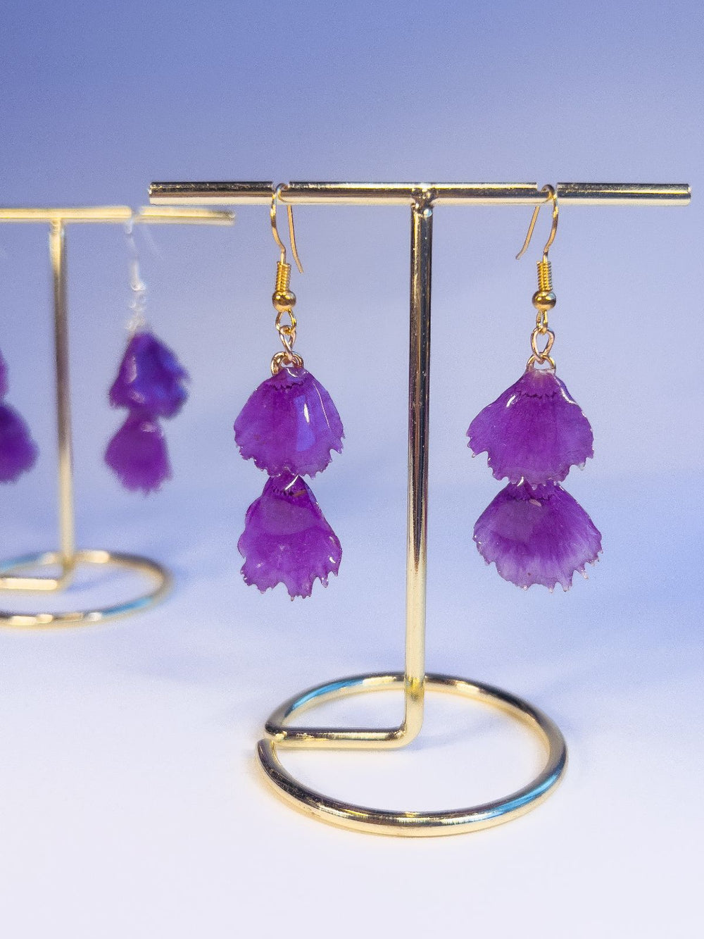 Both pairs of real dianthus flower petal dangles in purple.