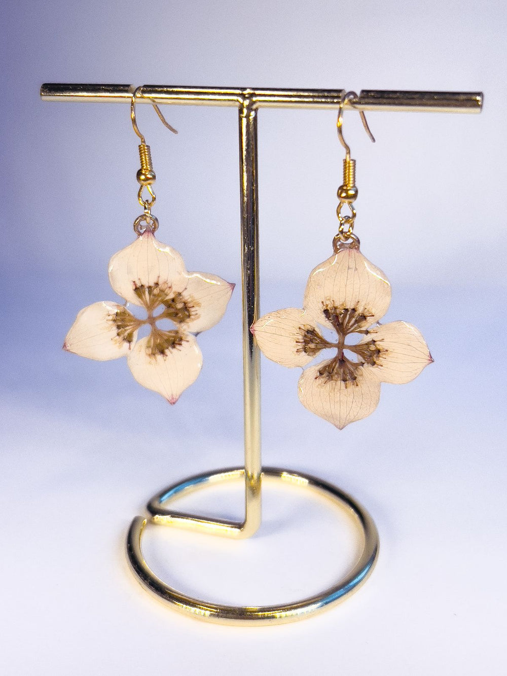 Dangle earrings made from real dogwood flowers, in gold. 