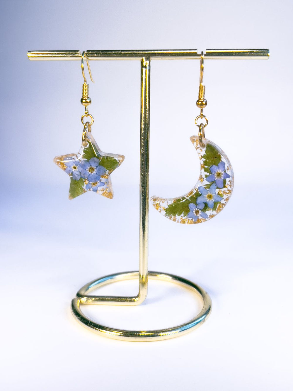 Moon and star dangle earrings made with pressed forget-me-nots and ferns. 