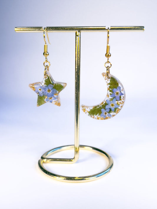 Moon and star dangle earrings made with pressed forget-me-nots and ferns. 