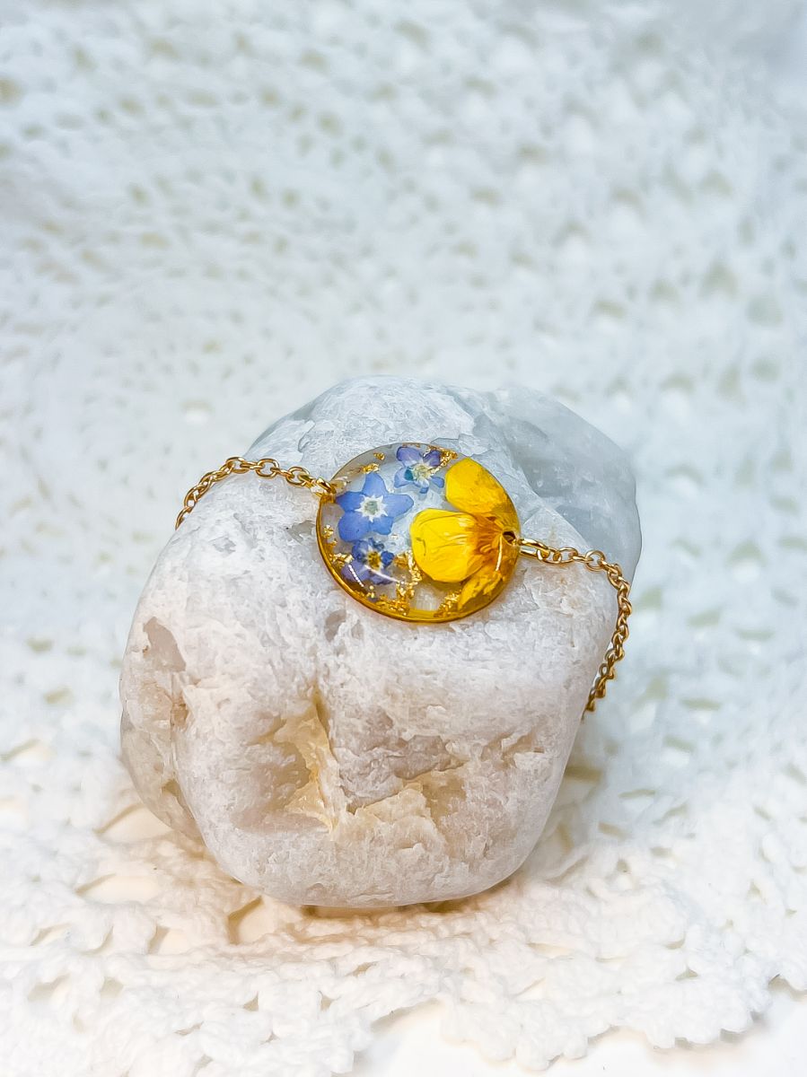 gold bracelet made with real pressed flowers- forget-me-nots and buttercups.