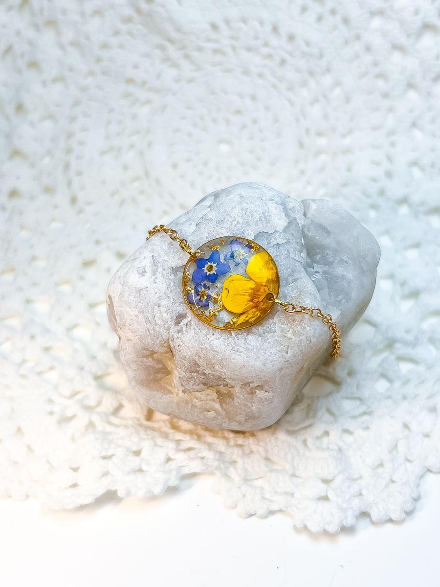 A bracelet made with real forget-me-nots and buttercups.
