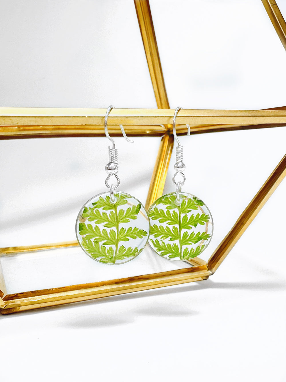 Round pendant dangle earrings made with real pressed ferns. 