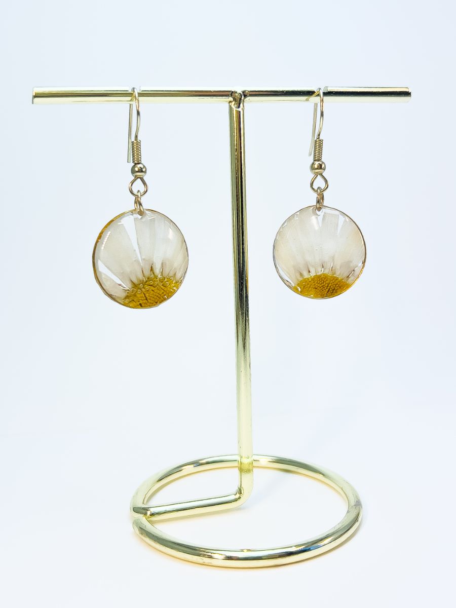 Medium size pressed daisy dangle earrings in silver.