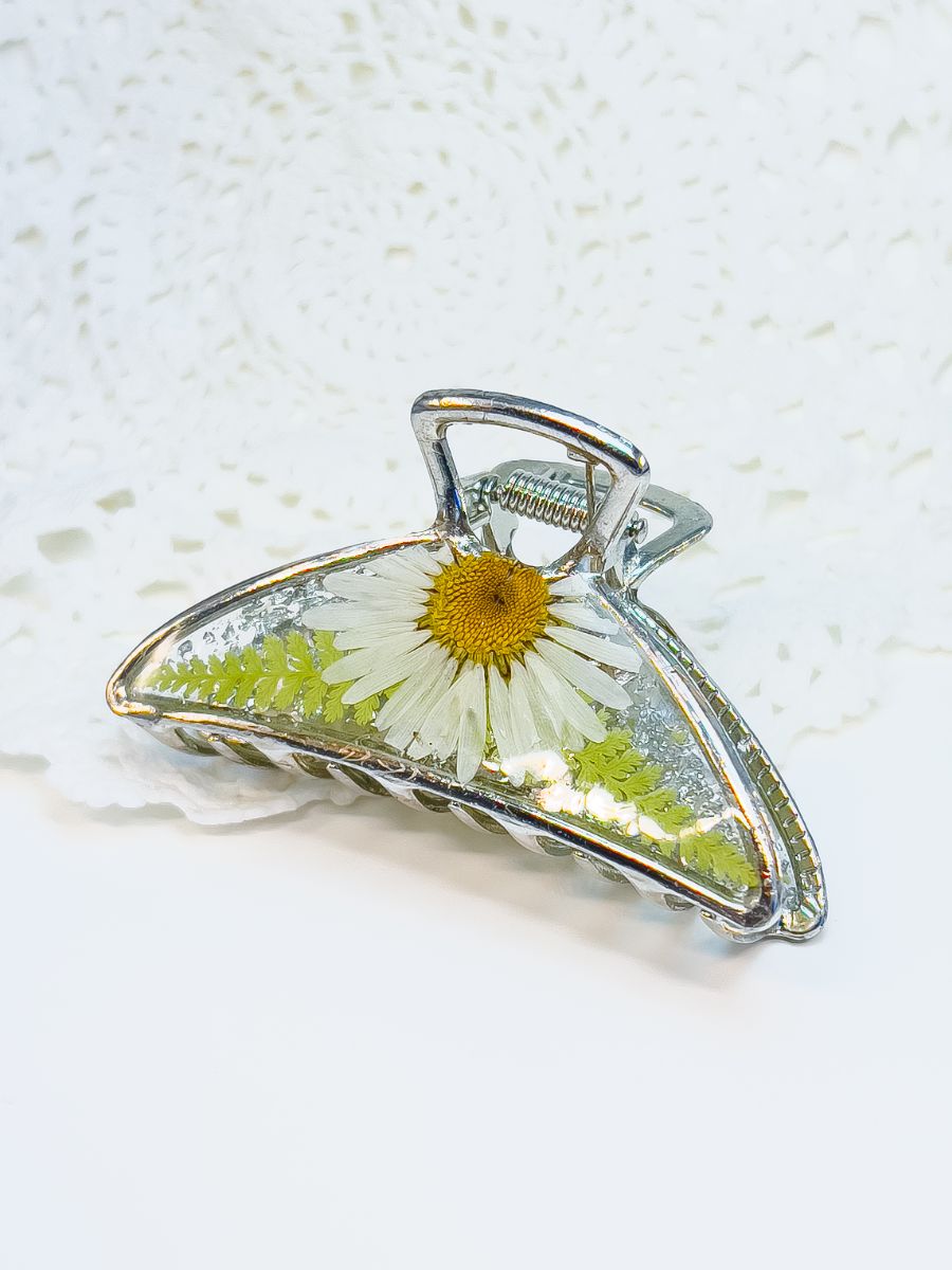 Silver metal hair clip made with pressed daisies.